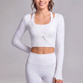 Front view of a white twist-front cropped athletic shrug with thumbholes.