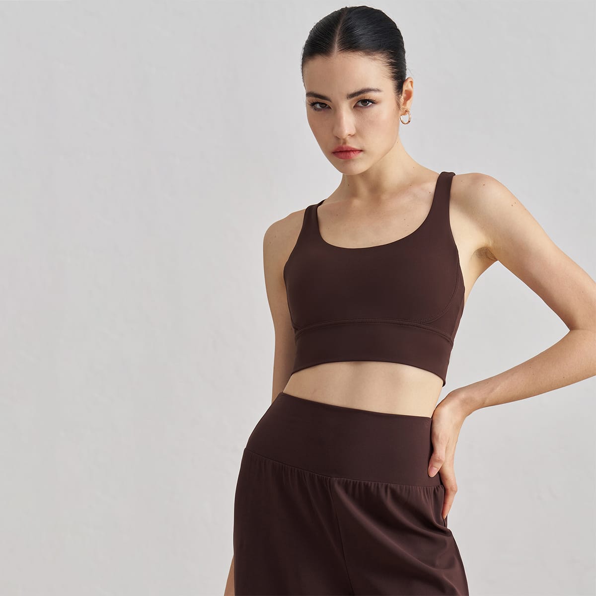 Front view of a women's chocolate brown scoop neck longline sports bra.
