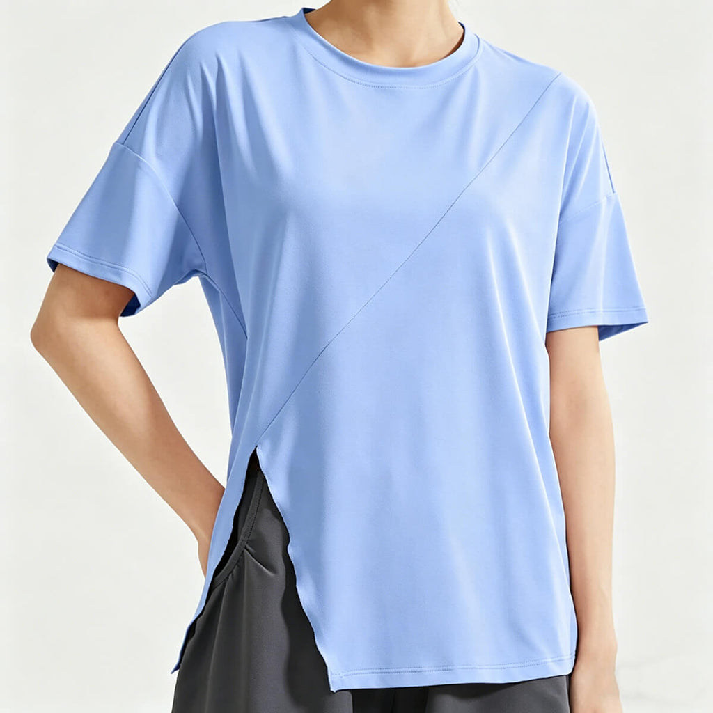 A women's light blue loose-fit workout shirt featuring a stylish side slit hem and breathable fabric, perfect for yoga and gym training.