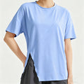 A women's light blue loose-fit workout shirt featuring a stylish side slit hem and breathable fabric, perfect for yoga and gym training.