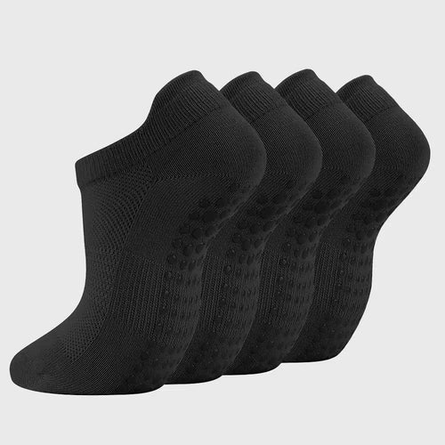 Bottom view showing silicone anti-slip grip dots on low cut black yoga socks with custom logo, custom sportswear manufacturer.