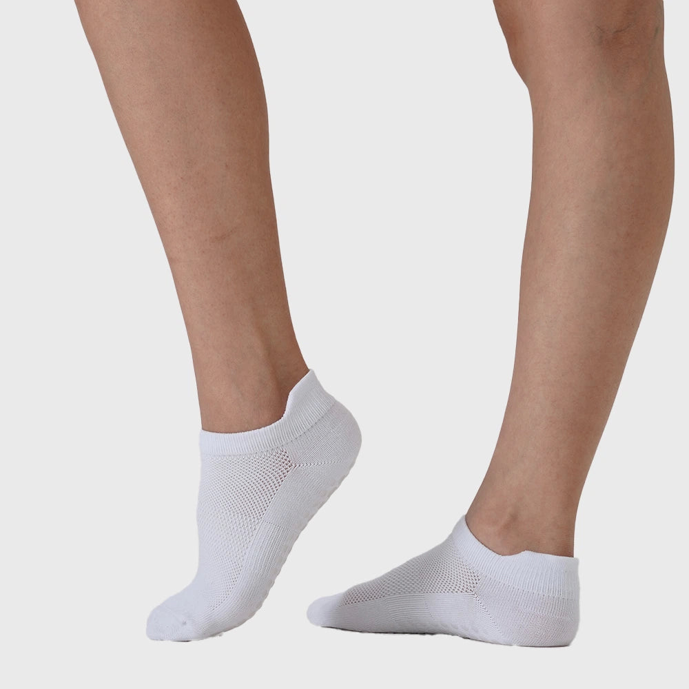 Side profile showing breathable mesh instep and heel tab on women's white grip socks with custom logo, sportswear manufacturer.
