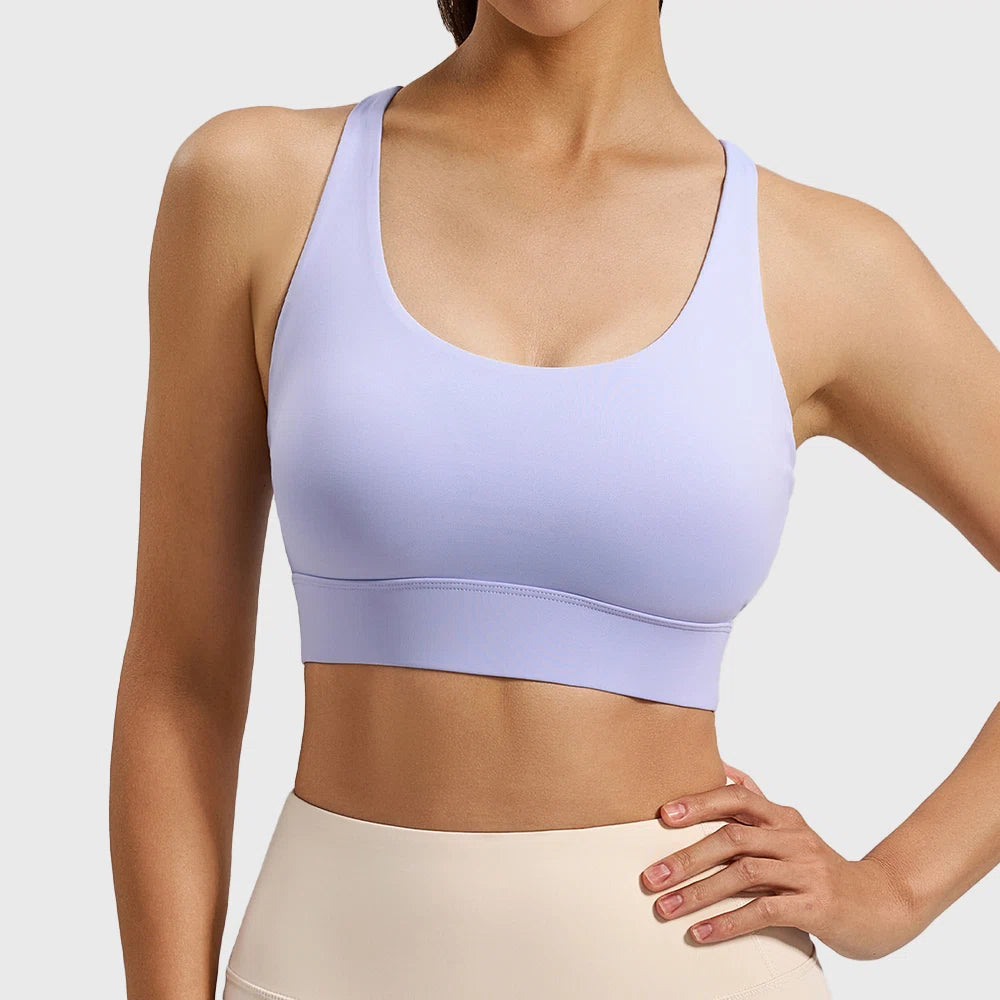 Front view of women's mesh insert racerback sports bra in lilac purple with custom logo, produced by activewear manufacturer.