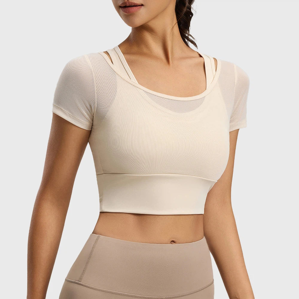 Women's sheer mesh short sleeve workout crop top with fixed pads in cream with custom logo, custom sportswear manufacturer - front view.
