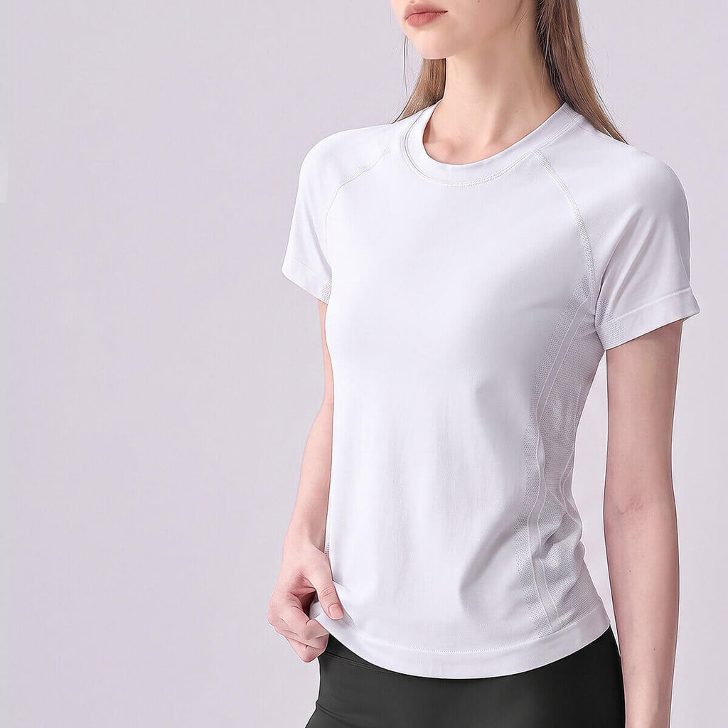 Woman wearing a crisp white short sleeve seamless training shirt.