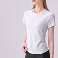 Woman wearing a crisp white short sleeve seamless training shirt.
