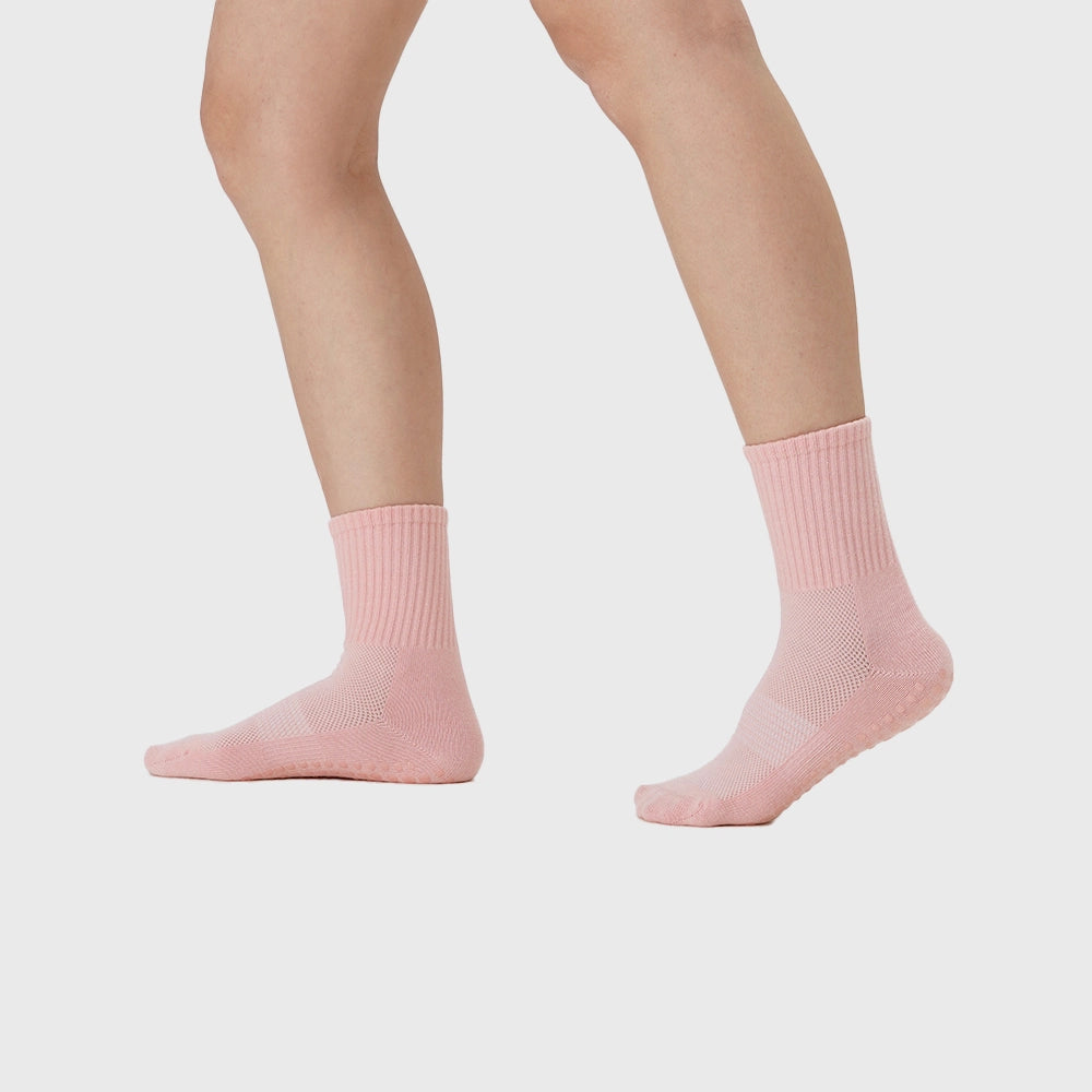 Movement fit view of women's non-slip pilates workout socks in pink with custom logo, sportswear manufacturer.