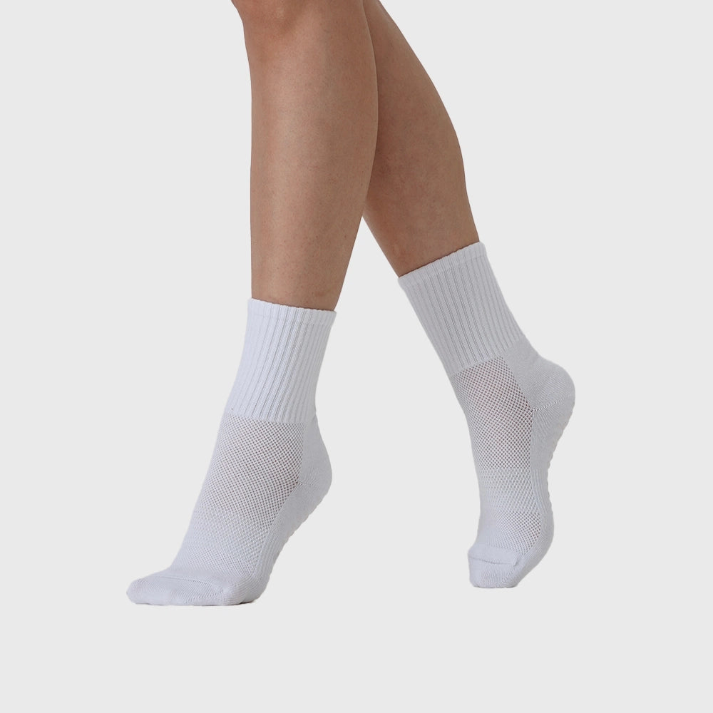 On-foot view of women's breathable mesh crew grip socks in white with custom logo, OEM gym wear manufacturer.