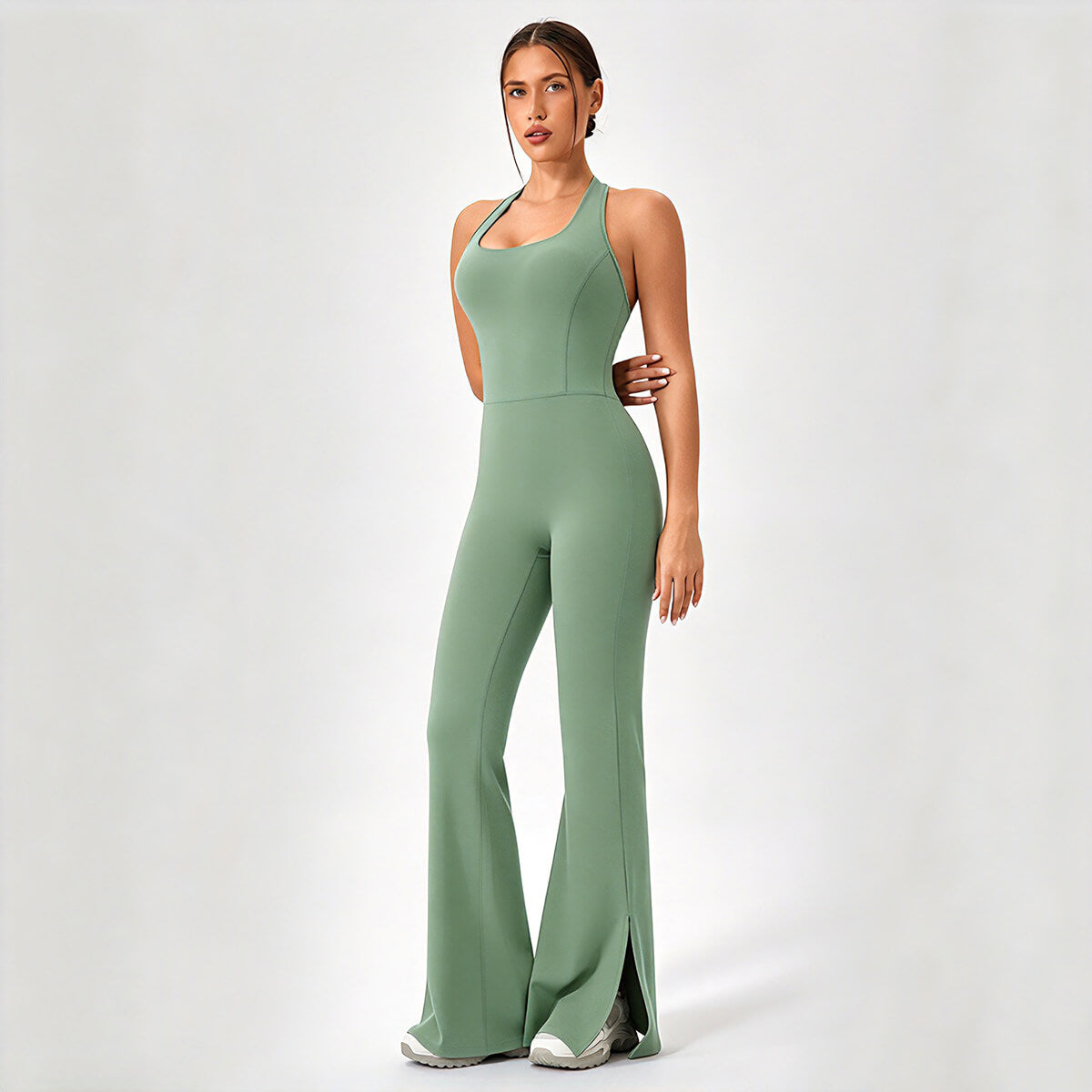 Front 3/4 view of a sage green halter-neck flare yoga jumpsuit.
