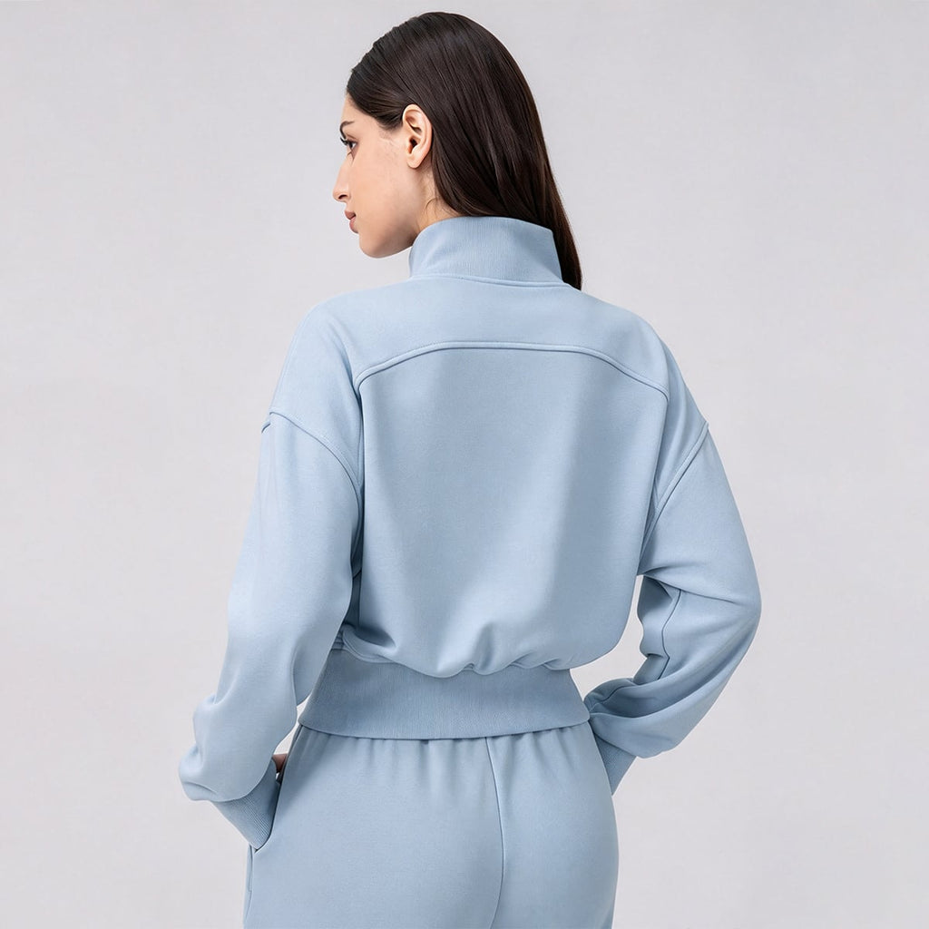 Back view of a sky blue cropped full-zip jacket showing drop shoulders.