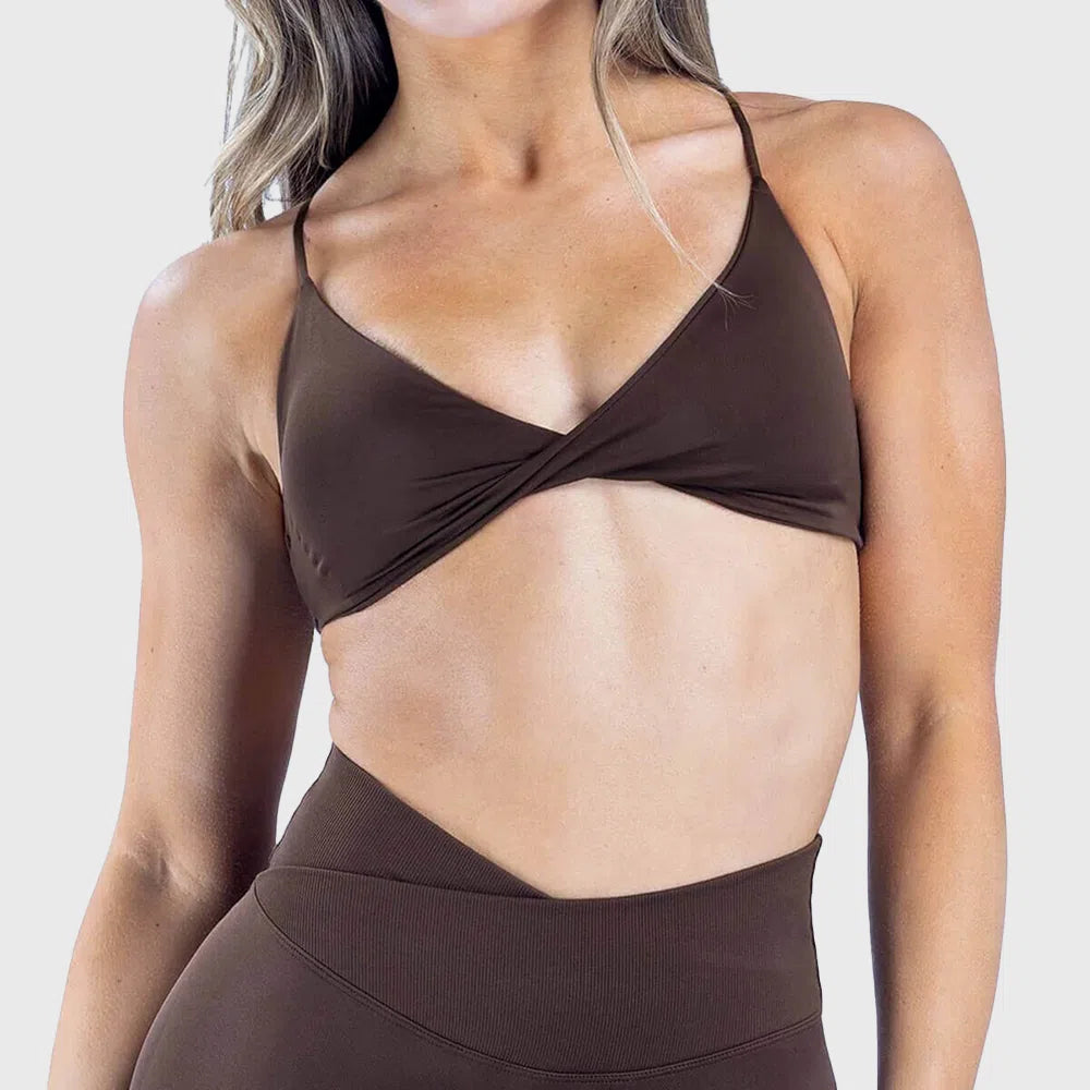 Front look of dark brown plunge twist yoga sports bra with custom logo, supplied by activewear manufacturer.
