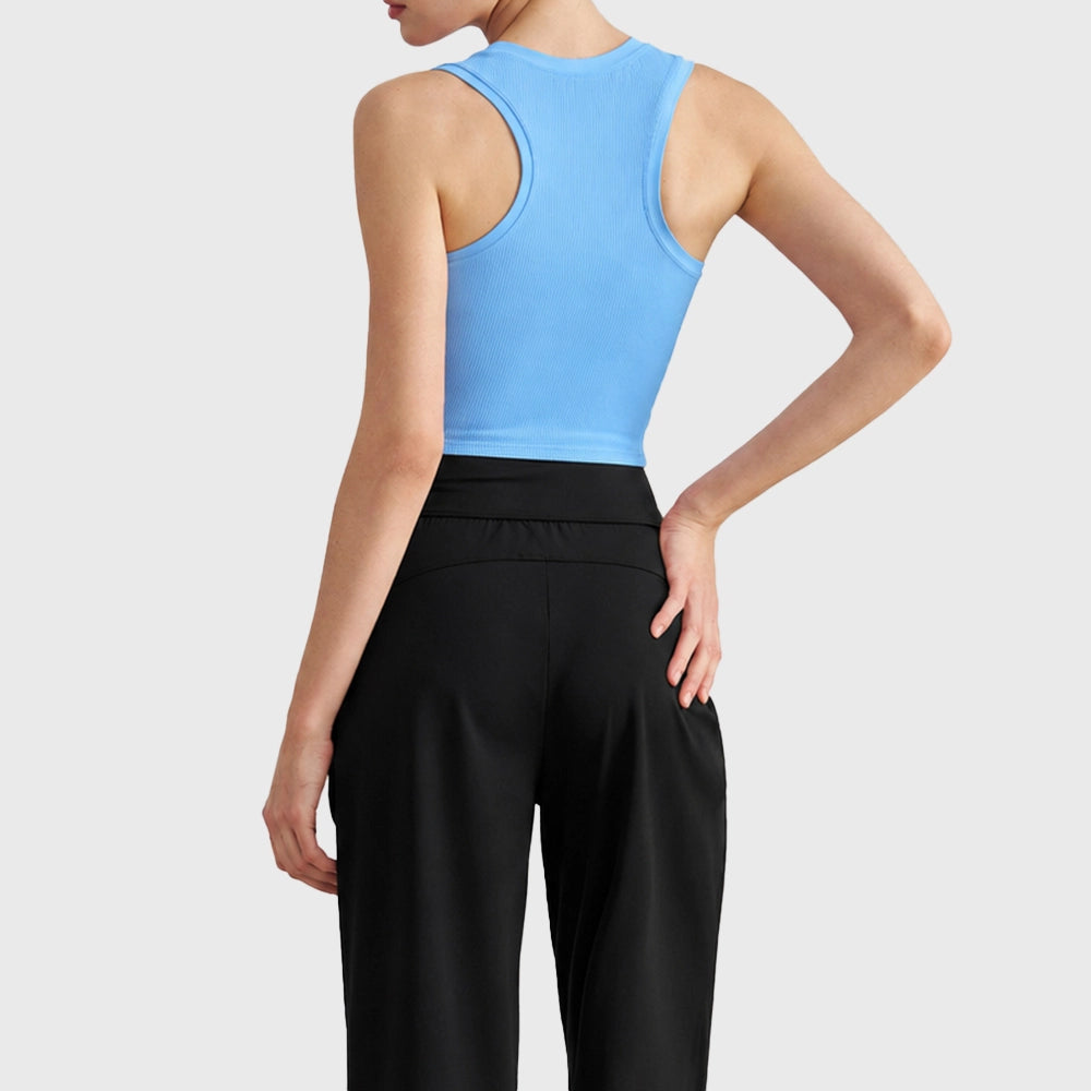 Racerback cut and back design of women's ribbed crop tank top with custom logo, manufactured by athletic apparel manufacturer.