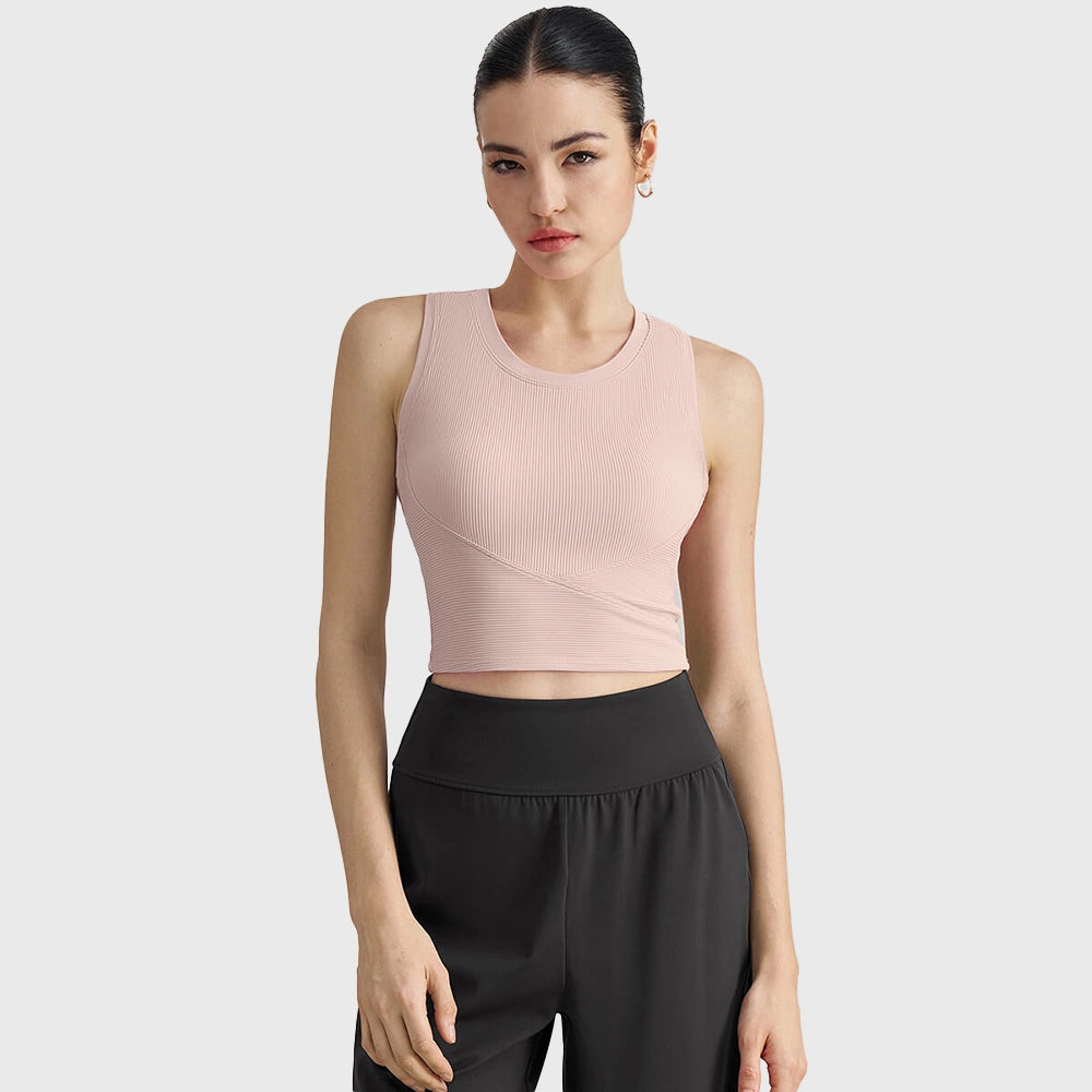 Blush pink ribbed yoga crop tank top featuring wrap hem and custom logo by activewear manufacturer.