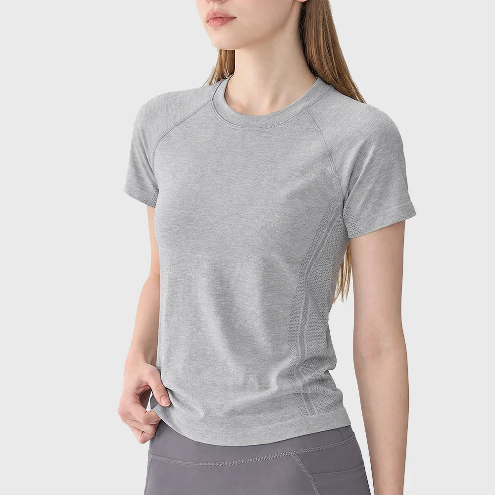 Heather grey women's seamless running t-shirt featuring breathable mesh panels and custom logo, made by gym apparel manufacturer.