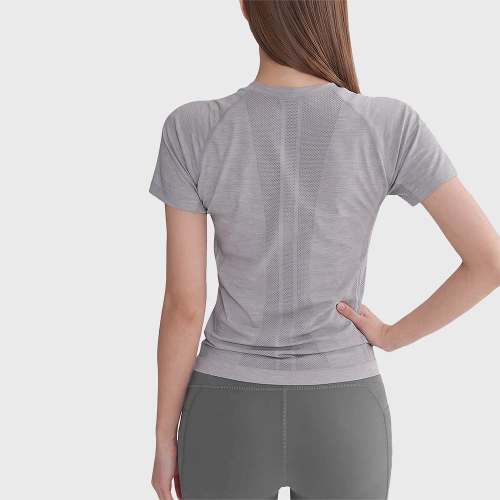 Back ventilation mesh pattern on women's seamless running t-shirt with custom logo option by fitness apparel manufacturer.