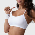 Women's skinny strap athletic running sports bra in white with custom logo, custom sportswear manufacturer - front view.