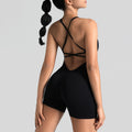 Back view of women's seamless open back workout romper in black with custom logo, private label manufacturer.