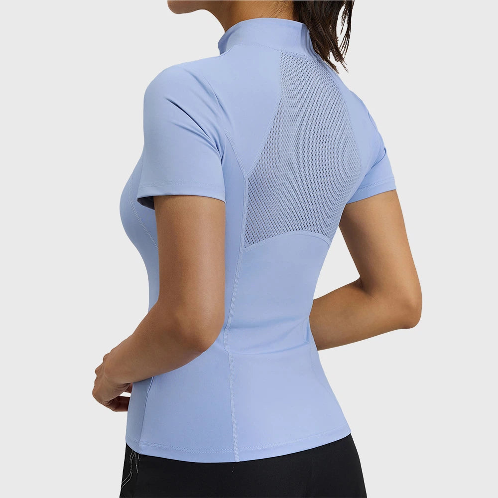Back view showing breathable mesh splicing on women's athletic top in periwinkle blue with custom logo, private label manufacturer.
