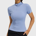 Women's short sleeve half zip slim fit workout top in periwinkle blue with custom logo, custom sportswear manufacturer - front view.
