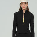 Woman wearing a classic black full-zip athletic training jacket.