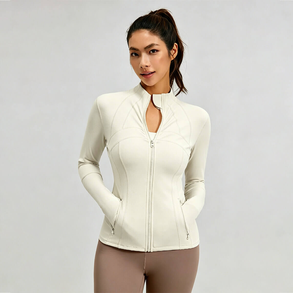 Slim fit milky white yoga jacket for women with full zip and contouring seams for workout.