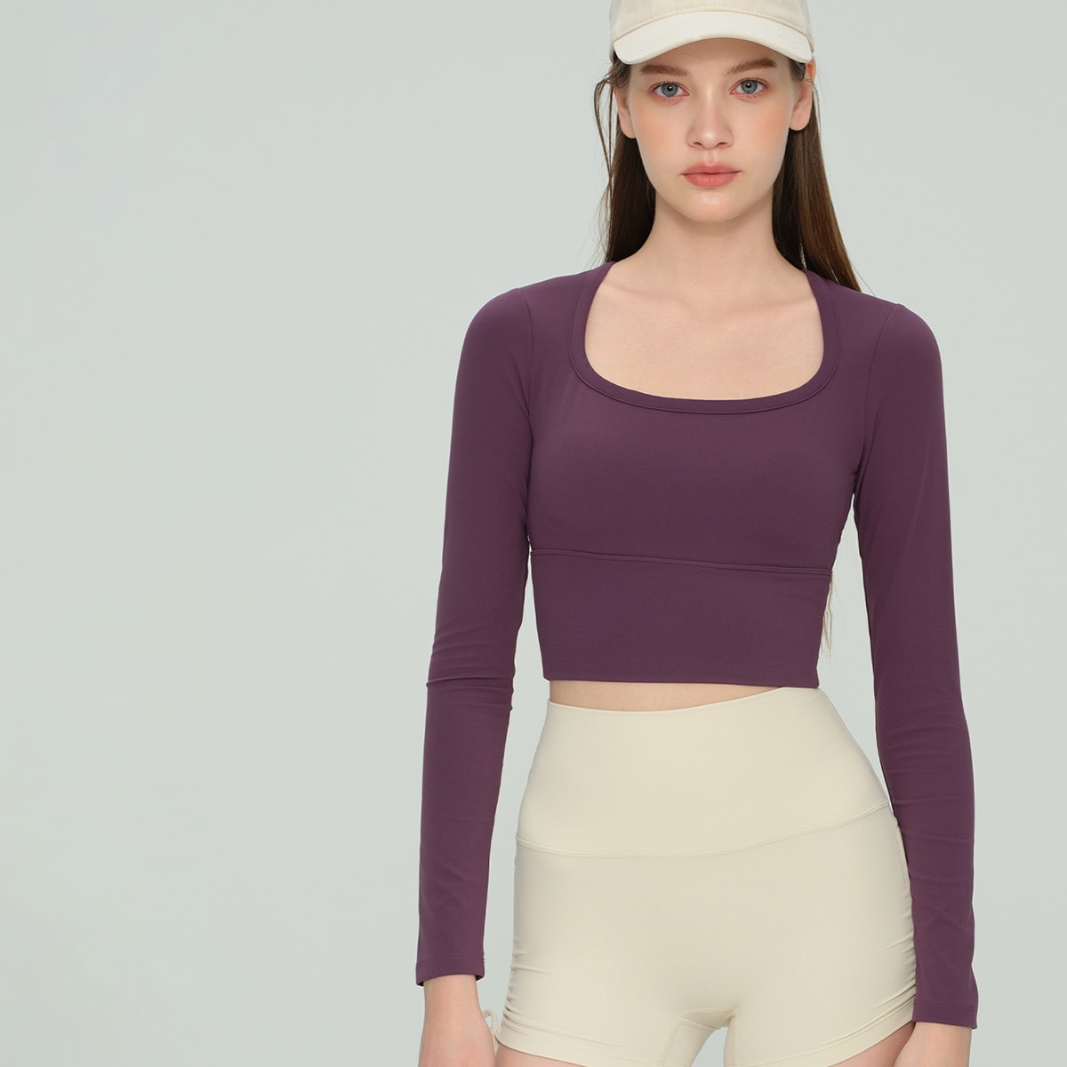 Front view of a deep plum square neck long-sleeve gym crop top.