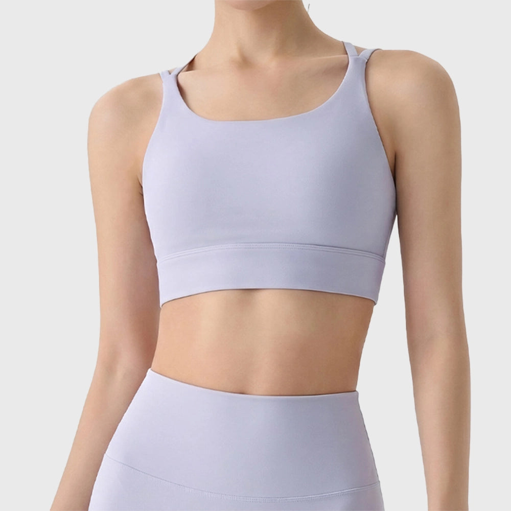 Front view of women's square neck double strap sports bra in lilac with custom logo, produced by activewear manufacturer.
