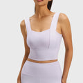 Women's high impact longline workout tank bra with fixed cups in lilac with custom logo, private label manufacturer - front view.