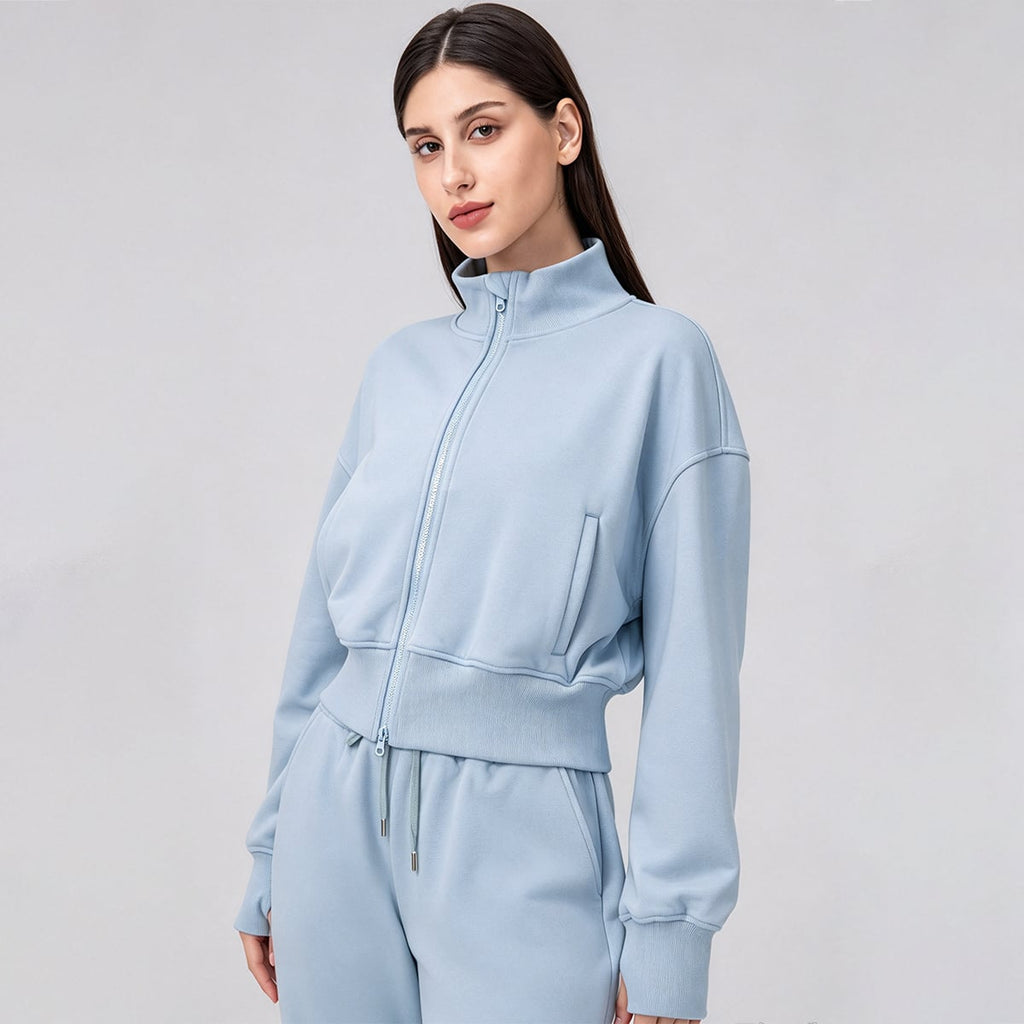 Front 3/4 view of a sky blue stand-collar cropped fleece jacket.