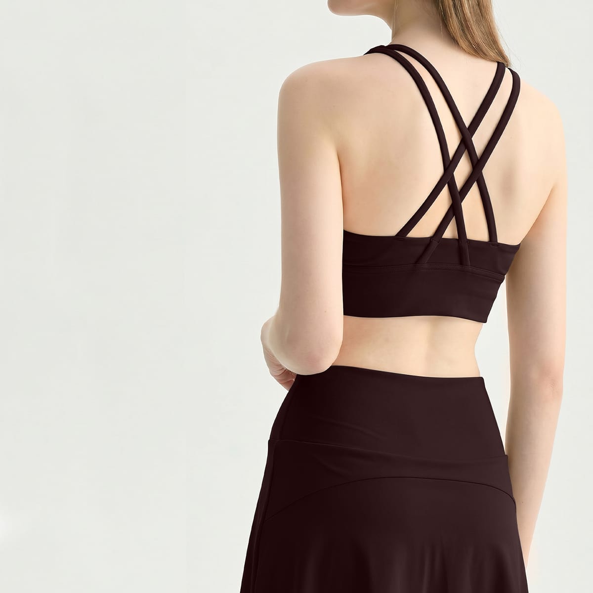 Back view of a coffee strappy criss-cross workout sports bra.
