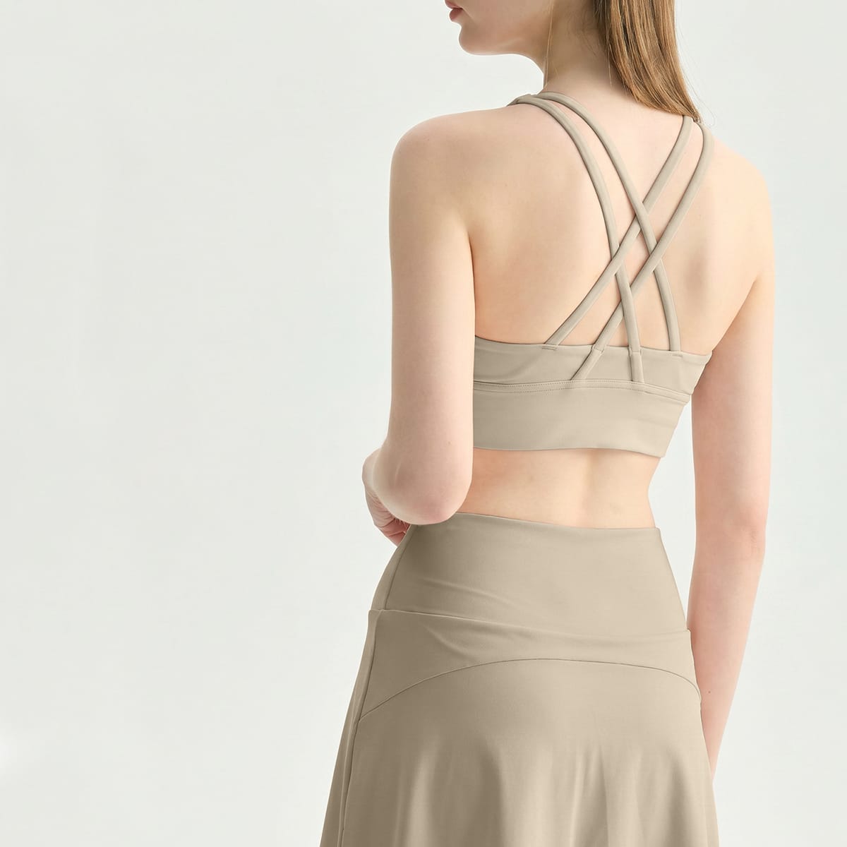 Back view of a khaki beige strappy criss-cross longline yoga bra.