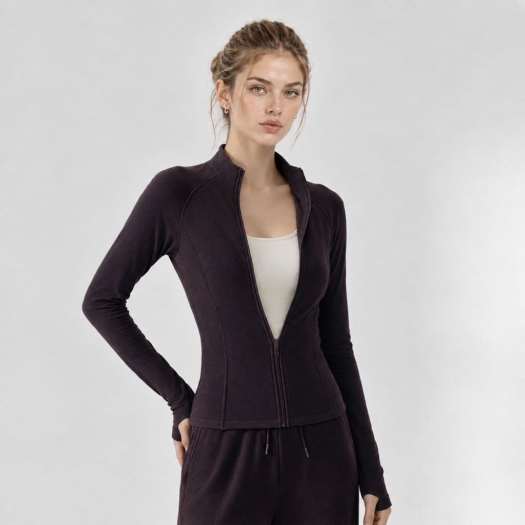 Model wearing a deep plum slim-fit thermal running jacket unzipped at the chest.