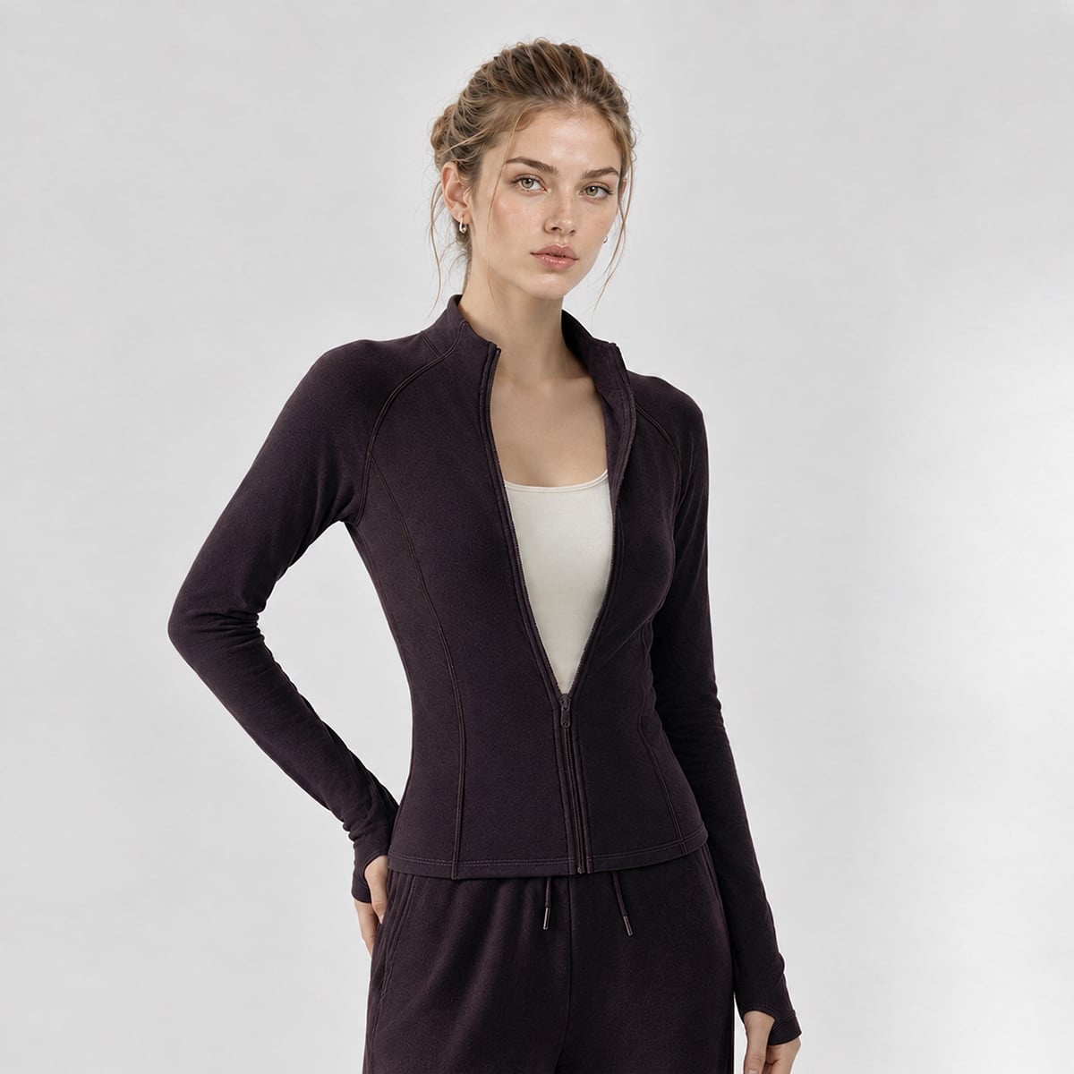 Model wearing a deep plum slim-fit thermal running jacket unzipped at the chest.