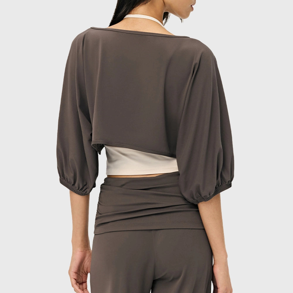 Back view of women's puff sleeve cropped yoga shrug in mocha brown with custom logo, activewear manufacturer.