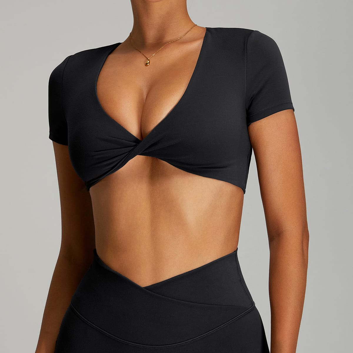 Classic black short-sleeve V-neck twist-front workout crop top front view.