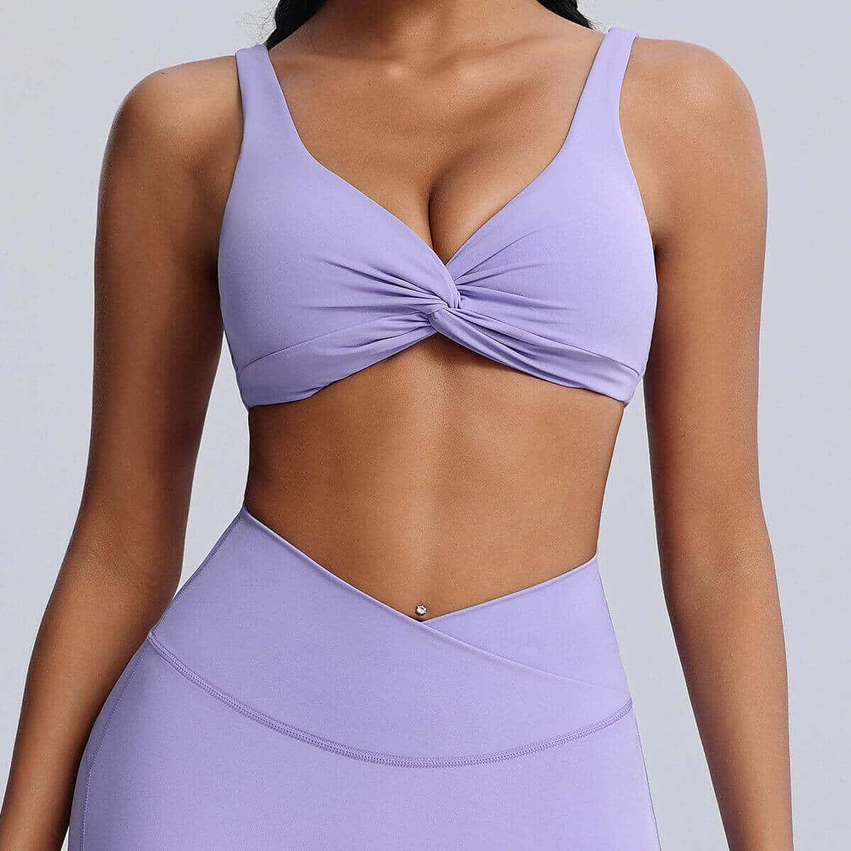  Front view of a pastel lavender purple twist-front sports bra.