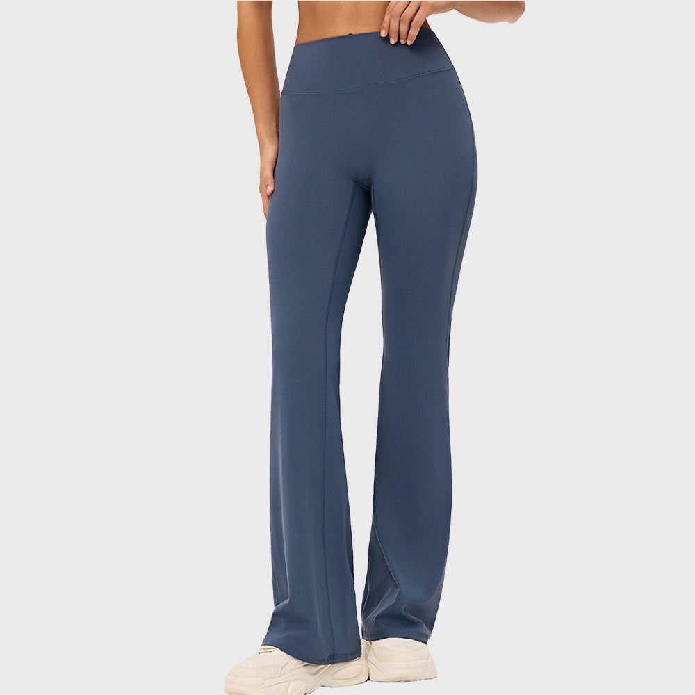 Front 3/4 view of women's tummy control flared workout pants in steel blue with custom logo, sportswear manufacturer.