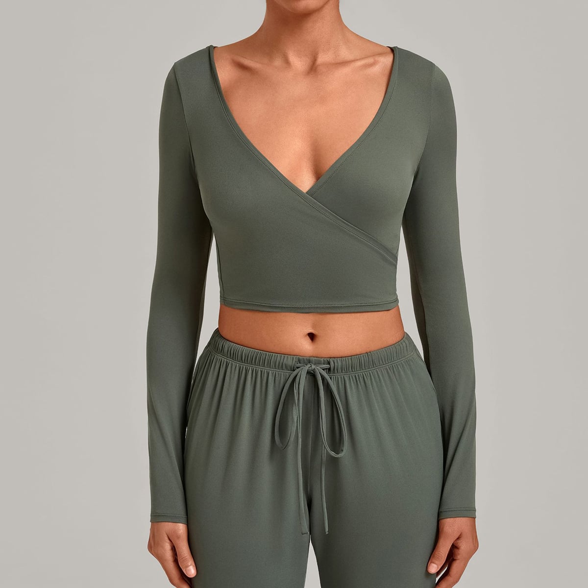 Front view of a sage green cross-front yoga wrap crop shirt.