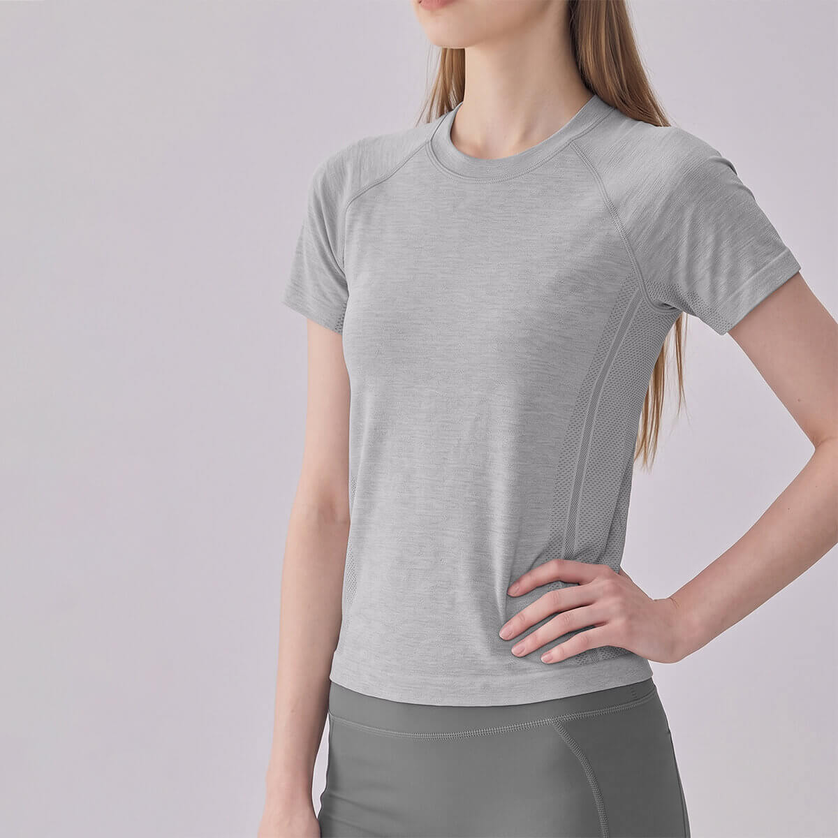 Side view of heather grey workout shirt showing breathable mesh detailing.