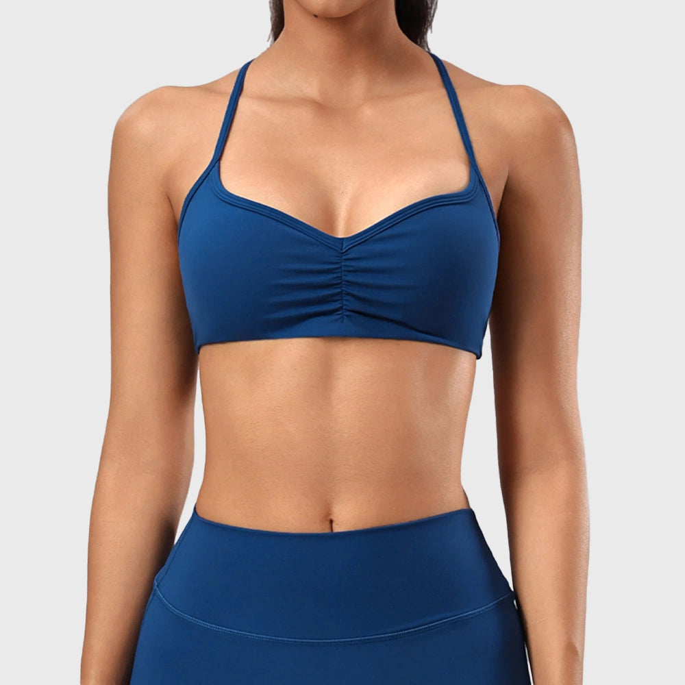 Women's low impact ruched yoga bralette in teal blue with custom logo, direct clothing manufacturer - front view.