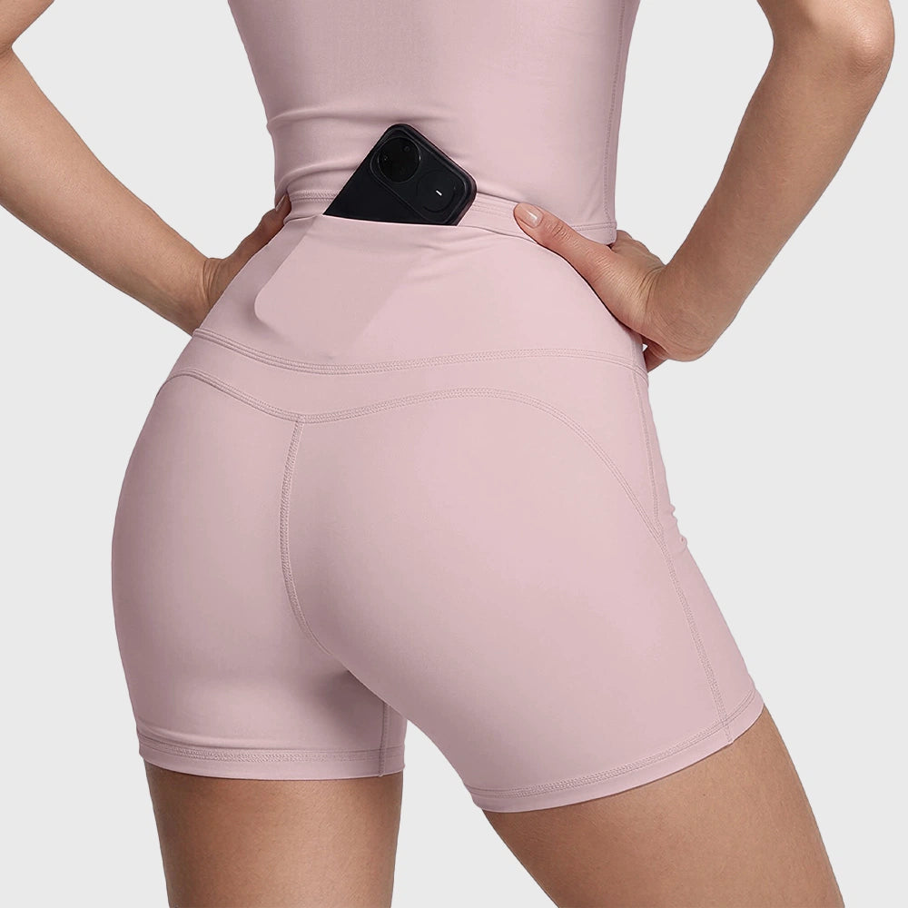 Back waistband phone pocket feature on women's pink yoga shorts with custom logo, produced by activewear manufacturer.