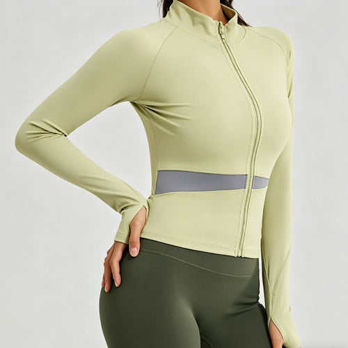 Close-up of a sage green workout zip-up jacket showing functional thumbholes and the flattering waist-contouring mesh design